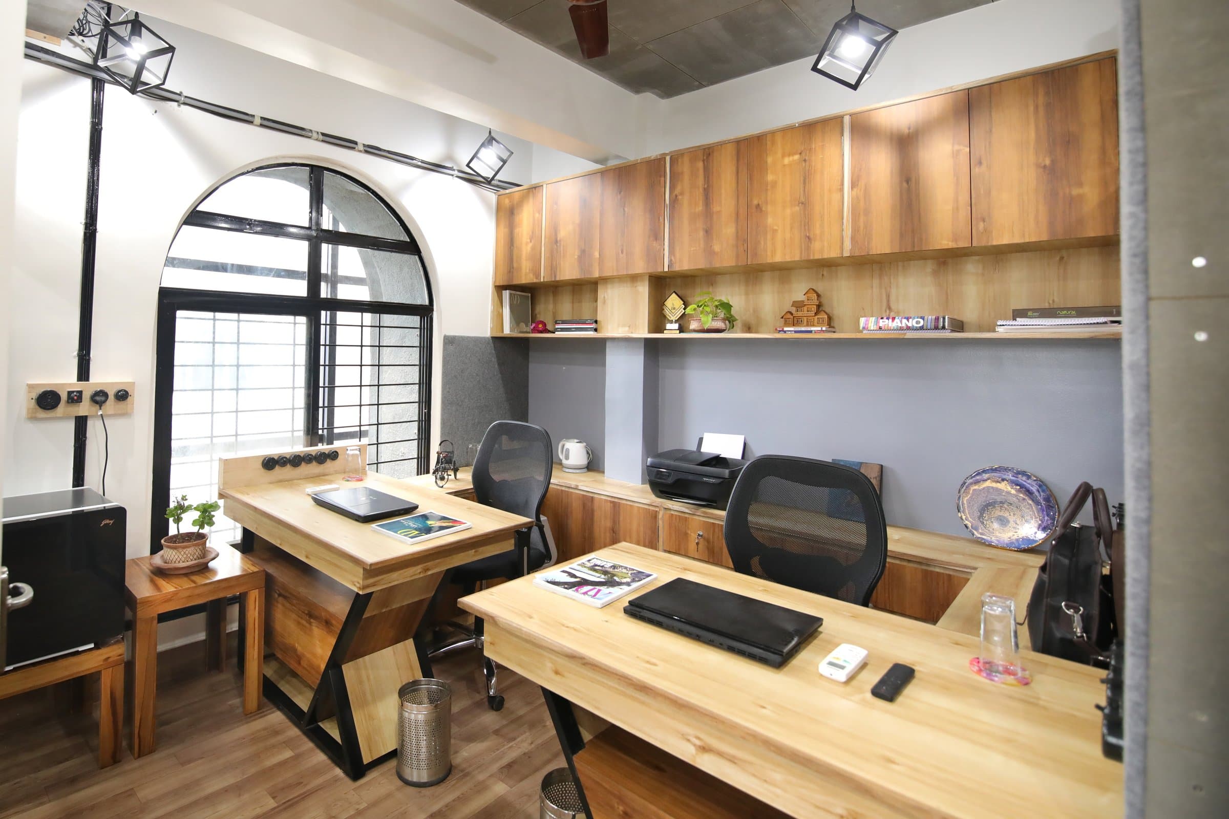 An industrial-loft studio anchored by a striking blue resin table — photo 10 of 16