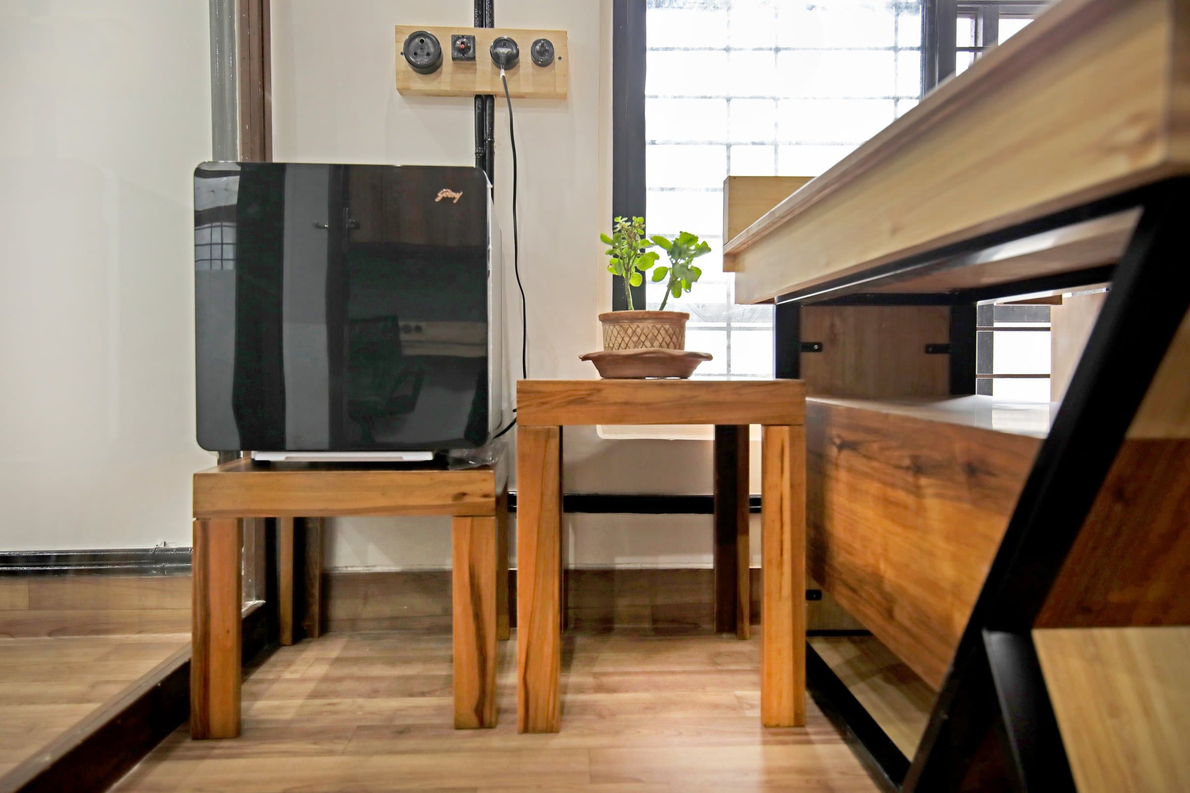 An industrial-loft studio anchored by a striking blue resin table — photo 2 of 16