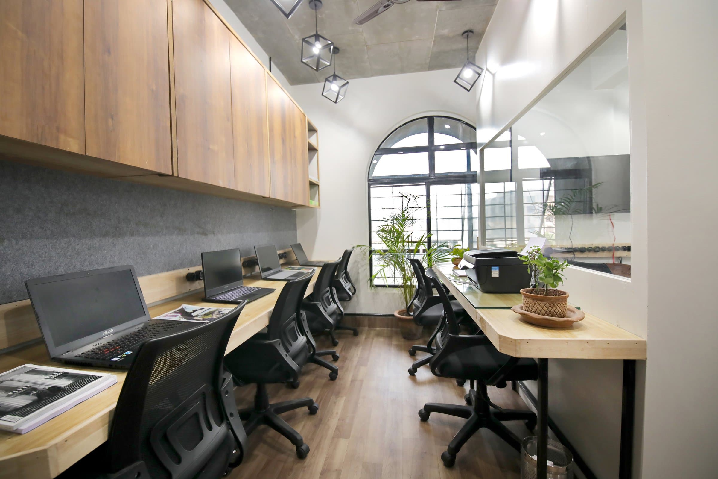 An industrial-loft studio anchored by a striking blue resin table — photo 4 of 16